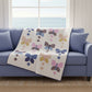 Blue sofa draped with a butterfly quilt in pastel colors designed by Coach House Designs