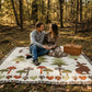 Quilt with owl, star, tree, and rabbit patterns on a beige background